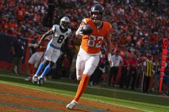 Denver Broncos tight end Adam Trautman (82) catches a pass for a touchdown against the Carolina Panthers during the first half of an NFL football game Sunday, Oct. 27, 2024, in Denver. (AP Photo/Bart Young)