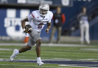 UNLV quarterback Hajj-Malik Williams (6) scrambles out of the pocket against Utah State in the first half of an NCAA college football game Friday, Oct. 11, 2024, in Logan, Utah. (Eli Lucero/The Herald Journal via AP)