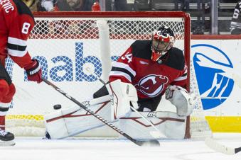 New Jersey Devils goaltender Jake Allen (34) deflects a puck during the second period of an NHL hockey game against the Utah Hockey Club, Monday, Oct. 14, 2024, in Newark, N.J. (AP Photo/Corey Sipkin).