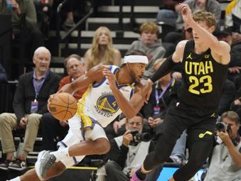 Golden State Warriors guard Moses Moody (4) drives against Utah Jazz forward Lauri Markkanen (23) in the first half of an NBA basketball game Friday, Oct. 25, 2024, in Salt Lake City. (AP Photo/George Frey)