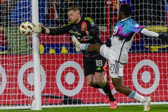 Real Salt Lake goalkeeper Zac MacMath (18) stops the shot from Minnesota United forward Bongokuhle Hlongwane (21) during an MLS soccer game, Tuesday, Oct. 29, 2024, in Salt Lake City. (AP Photo/Tyler Tate)