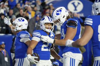 BYU running back LJ Martin, second from left, celebrates after scoring a touchdown in the second half of an NCAA college football game against Oklahoma State, Friday, Oct. 18, 2024, in Provo, Utah. (AP Photo/Spenser Heaps)