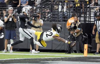 Pittsburgh Steelers running back Najee Harris (22) dives for a touchdown past Las Vegas Raiders cornerback Jack Jones (18) during the second half of an NFL football game at Allegiant Stadium Sunday, Oct. 13, 2024, in Las Vegas. (Steve Marcus/Las Vegas Sun via AP)