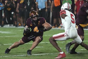Arizona State running back Cam Skattebo avoids Utah cornerback Zemaiah Vaughn (5) in the first half during an NCAA college football game, Friday, Oct. 11, 2024, in Tempe, Ariz. (AP Photo/Rick Scuteri)
