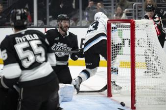 Los Angeles Kings defenseman Joel Edmundson (6) scores a goal past Utah Hockey Club left wing Matias Maccelli (63) during the second period of an NHL hockey game, Saturday, Oct. 26, 2024, in Los Angeles. (AP Photo/Kyusung Gong)