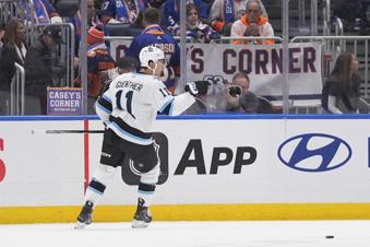 Utah Hockey Club's Dylan Guenther (11) celebrates after scoring the game winning goal during the overtime period of an NHL hockey game against the New York Islanders Thursday, Oct. 10, 2024, in Elmont, N.Y. (AP Photo/Frank Franklin II)