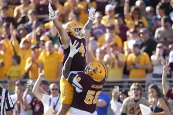 Arizona State running back Cam Skattebo (4) celebrates a touchdown run against BYU with offensive lineman Max Iheanachor (58) during the first half of an NCAA college football game Saturday, Nov. 23, 2024, in Tempe, Ariz. (AP Photo/Ross D. Franklin)