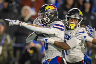 Kansas Jayhawks wide receiver Quentin Skinner, left, and Kansas wide receiver Trevor Wilson, right, celebrate a recovered fumble, during the second half of an NCAA college football game Saturday, Nov. 16, 2024, in Provo. (AP Photo/Rick Egan)