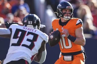 Denver Broncos quarterback Bo Nix (10) works in the pocket as Atlanta Falcons defensive tackle Kentavius Street (93) pressures during the first half of an NFL football game, Sunday, Nov. 17, 2024, in Denver. (AP Photo/David Zalubowski)