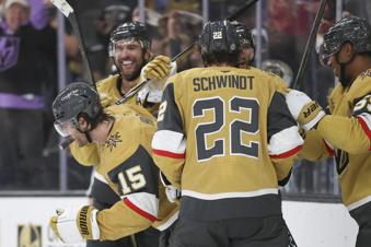 Vegas Golden Knights defenseman Noah Hanifin (15) celebrates with teammates after scoring a goal during the second period of an NHL hockey game against the Utah Hockey Club, Saturday, Nov. 2, 2024, in Las Vegas. (AP Photo/Ian Maule)