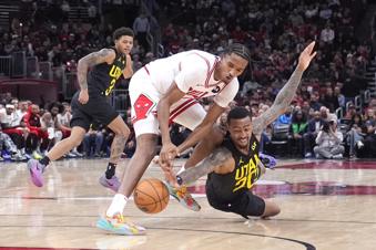 Chicago Bulls' Julian Phillips, left, and Utah Jazz's John Collins battle for a loose ball during the second half of an NBA basketball game Monday, Nov. 4, 2024, in Chicago. (AP Photo/Charles Rex Arbogast)