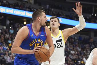Denver Nuggets center Nikola Jokic, left, pulls in a rebound as Utah Jazz center Walker Kessler defends in the second half of an NBA basketball game Saturday, Nov. 2, 2024, in Denver. (AP Photo/David Zalubowski)
