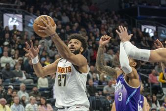 Denver Nuggets guard Jamal Murray (27) gets past Utah Jazz guard Keyonte George (3) as he goes to the hoop, during the first half of an NBA basketball game Wednesday, Nov. 27, 2024, in Salt Lake City. (AP Photo/Rick Egan)