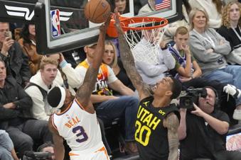 Phoenix Suns guard Bradley Beal (3) goes to the basket as Utah Jazz forward John Collins (20) defends during the first half of an Emirates NBA Cup basketball game Tuesday, Nov. 12, 2024, in Salt Lake City. (AP Photo/Rick Bowmer)