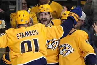 Nashville Predators left wing Filip Forsberg, center, celebrates his second goal of the game with Steven Stamkos (91) during the second period of an NHL hockey game against the Utah Hockey Club Saturday, Nov. 9, 2024, in Nashville, Tenn. (AP Photo/Mark Humphrey)