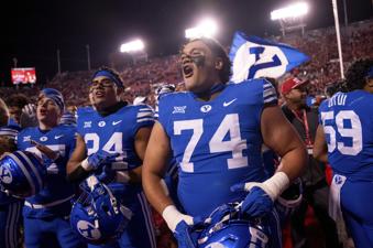 BYU offensive lineman Trevin Ostler (74) celebrates after beating Utah in an NCAA college football game, just after midnight on Sunday, Nov. 10, 2024, in Salt Lake City. (AP Photo/Spenser Heaps)