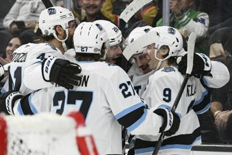 The Utah Hockey Club celebrates their fourth goal against the Vegas Golden Knights during the first period of an NHL hockey game Saturday, Nov. 30, 2024, in Las Vegas. (AP Photo/Sam Morris)