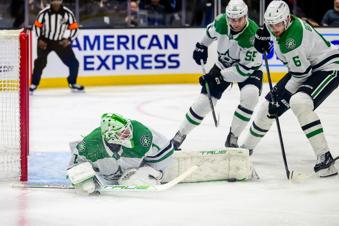 Dallas Stars goaltender Casey DeSmith (1) makes a save with his leg during the first period of an NHL hockey game against the Utah Hockey Club, Monday, Dec. 23, 2024, in Salt Lake City. (AP Photo/Tyler Tate)