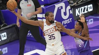 Utah Jazz guard Collin Sexton (2) defends against Phoenix Suns forward Kevin Durant (35) during the first half of an NBA basketball game Friday, Dec. 13, 2024, in Salt Lake City. (AP Photo/Rick Bowmer)