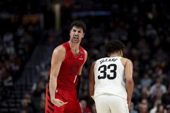 Portland Trail Blazers forward Deni Avdija, left, reacts to Utah Jazz guard Johnny Juzang, right, during the second half of an NBA basketball game Thursday, Dec. 26, 2024, in Portland, Ore. (AP Photo/Howard Lao)