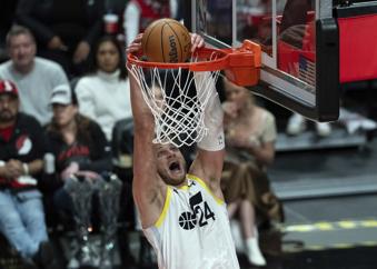 Utah Jazz center Walker Kessler (24) dunks during the first half of an NBA basketball game against the Portland Trail Blazers, Friday, Dec. 6, 2024, in Portland, Ore. (AP Photo/Jenny Kane)