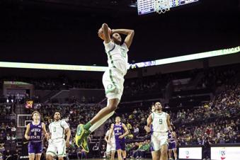 Oregon forward Kwame Evans Jr. (10) goes up to dunk against Weber State during the first half of an NCAA college basketball game in Eugene, Ore., Sunday, Dec. 29, 2024. (AP Photo/Thomas Boyd)