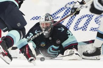Seattle Kraken goaltender Philipp Grubauer blocks a shot against the Utah Hockey Club during the second period of an NHL hockey game Monday, Dec. 30, 2024, in Seattle. (AP Photo/Lindsey Wasson)