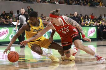 Utah guard Gabe Madsen and Baylor guard VJ Edgecombe reach for a loose ball during the first half of an NCAA college basketball game Tuesday, Dec. 31, 2024, in Waco, Texas. (AP Photo/Jerry Larson)