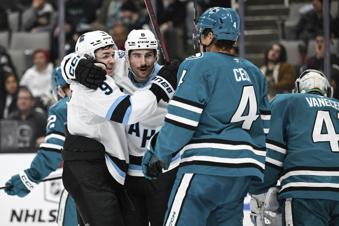 Utah Hockey Club center Nick Schmaltz (8) celebrates his goal with center Clayton Keller (9) against the San Jose Sharks during the second period of an NHL hockey game Saturday, Dec. 14, 2024, in San Jose, Calif. (AP Photo/Eakin Howard)