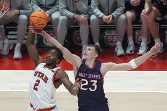 Saint Mary's forward Paulius Murauskas (23) defends against Utah forward Ezra Ausar (2) during the second half of an NCAA college basketball game Saturday, Dec. 7, 2024, in Salt Lake City. (AP Photo/Rick Bowmer)