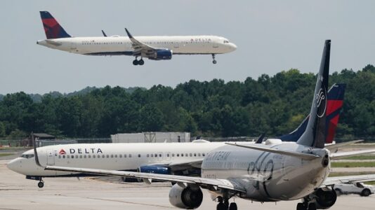 Passengers evacuate plane on slides after Delta flight aborts takeoff