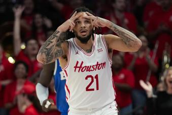 Houston guard Emanuel Sharp (21) reacts after making a 3-pointer during the first half of an NCAA college basketball game against the Brigham Young in Houston, Saturday, Jan. 4, 2025. (AP Photo/Ashley Landis)