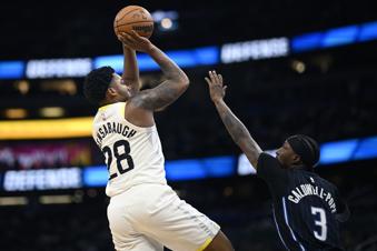 Utah Jazz forward Brice Sensabaugh (28) shoots in front of Orlando Magic guard Kentavious Caldwell-Pope (3) during the first half of an NBA basketball game, Sunday, Jan. 5, 2025, in Orlando, Fla. (AP Photo/Phelan M. Ebenhack)