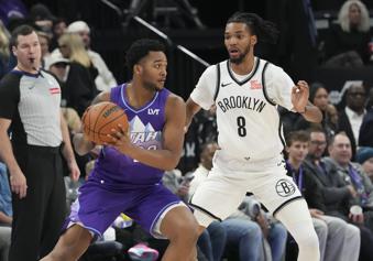 Utah Jazz forward Brice Sensabaugh, front left, looks to pass the ball around Brooklyn Nets forward Ziaire Williams (8) during the first half of an NBA basketball game Sunday, Jan. 12, 2025, in Salt Lake City. (AP Photo/Bethany Baker)