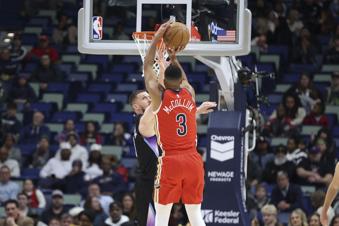 New Orleans Pelicans guard CJ McCollum (3) shoots a 3-pointer over Utah Jazz guard Svi Mykhailiuk in the first half of an NBA basketball game in New Orleans, Monday, Jan. 20, 2025. (AP Photo/Peter Forest)