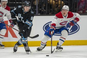 Utah Hockey Club center Clayton Keller (9) races Montreal Canadiens center Christian Dvorak (28) to the puck, during the second period of an NHL hockey game Tuesday, Jan. 14, 2025, in Salt Lake City. (AP Photo/Rick Egan)