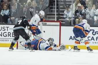 New York Islanders defenseman Adam Pelech (3) and goalie Marcus Hogberg (50) blocks the goal against Utah Hockey Club center Clayton Keller (9) during the second period of an NHL hockey game Saturday, Jan. 11, 2025, in Salt Lake City. (AP Photo/Melissa Majchrzak)