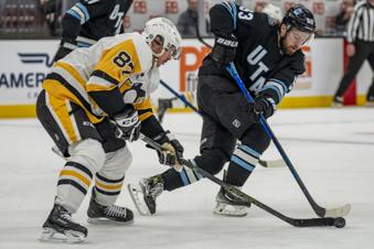 Pittsburgh Penguins center Sidney Crosby (87) and Utah Hockey Club left wing Michael Carcone (53) go for the puck, during the second period of an NHL hockey game Wednesday, Jan. 29, 2025, in Salt Lake City. (AP Photo/Rick Egan)