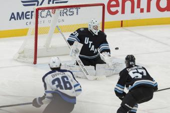 Utah Hockey Club goaltender Connor Ingram (39) blocks the puck against Winnipeg Jets center Morgan Barron (36) during the third period of an NHL hockey game Monday, Jan. 20, 2025, in Salt Lake City. (AP Photo/Melissa Majchrzak)
