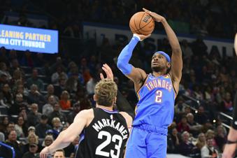 Oklahoma City Thunder guard Shai Gilgeous-Alexander (2) shoots over Utah Jazz forward Lauri Markkanen (23) during the first half of an NBA basketball game, Wednesday, Jan. 22, 2025, in Oklahoma City. (AP Photo/Kyle Phillips)