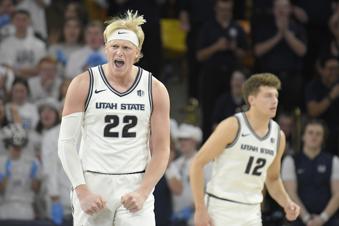 Utah State forward Karson Templin (22) celebrates after Boise State turned the ball over in the second half of an NCAA college basketball game Saturday, Jan. 11, 2025, in Logan, Utah. (AP Photo/Eli Lucero)