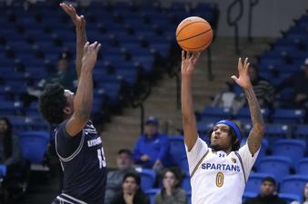 San Jose State guard Donavan Yap (0) shoots a 3-point shot against Utah State guard Deyton Albury (13) during the second half of an NCAA college basketball game Tuesday, Jan. 7, 2025, in San Jose, Calif. (AP Photo/Tony Avelar)
