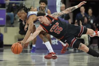 Utah guard Gabe Madsen (55) and TCU forward Trazarien White reach for the ball during the first half of an NCAA college basketball game Wednesday, Jan. 15, 2025, in Fort Worth, Texas. (AP Photo/LM Otero)