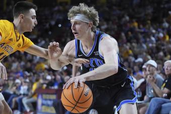 Brigham Young forward Richie Saunders (15) works to get around Arizona State guard Bobby Hurley (11) during the first half of an NCAA college basketball game Wednesday, Feb. 26, 2025, in Tempe, Ariz. (AP Photo/Darryl Webb)