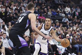 Sacramento Kings forward Keegan Murray (13) passes the ball as Utah Jazz center Walker Kessler (24) defends during the first half of an NBA basketball game, Wednesday, Feb. 26, 2025, in Salt Lake City. (AP Photo/Rob Gray)