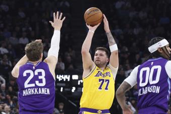 Los Angeles Lakers guard Luka Doncic (77) shoots over Utah Jazz forward Lauri Markkanen (23) and guard Jordan Clarkson (00) during the first quarter of an NBA basketball game, Wednesday, Feb. 12, 2025, in Salt Lake City. (AP Photo/Rob Gray)