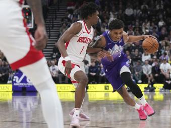 Utah Jazz guard Keyonte George (3) dribbles past Houston Rockets forward Amen Thompson (1) during the first half of an NBA basketball game Saturday, Feb. 22, 2025, in Salt Lake City. (AP Photo/Bethany Baker)