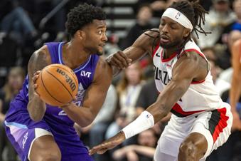 Utah Jazz forward Brice Sensabaugh, left, looks downcourt as Portland Trail Blazers forward Jerami Grant, right, defends during the first half of an NBA basketball game Monday, Feb. 24, 2025, in Salt Lake City. (AP Photo/Rick Egan)