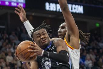 Utah Jazz guard Isaiah Collier, left, is guard by Golden State Warriors forward Kevon Looney (5), during the first half of an NBA basketball game against the Utah Jazz Wednesday, Feb. 5, 2025, in Salt Lake City. (AP Photo/Rick Egan)