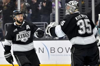 Los Angeles Kings defenseman Drew Doughty, left, fist pumps Kings goaltender Darcy Kuemper (35) after scoring a goal during the first period of an NHL hockey game against the Utah Hockey Club, Saturday, Feb. 22, 2025, in Los Angeles. (AP Photo/Jayne-Kamin-Oncea)
